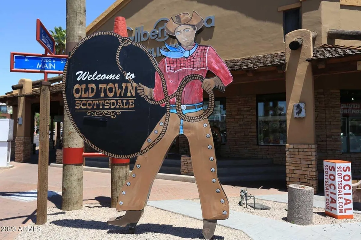 A lively street scene featuring a 'Welcome' sign, a cowboy figure, and the facade of a local building, evoking the character and charm of nearby Old Town Scottsdale. The mood is cheerful, making it ideal for tourism and local exploration.
